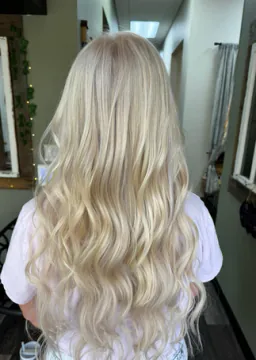 Long platinum blonde hair shown from crown through softly waved ends