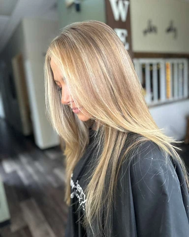 Fresh long layered haircut with face framing and polished movement